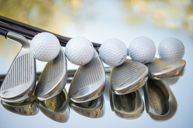 Image of golf balls and golf clubs by Cristina Anne Costello
