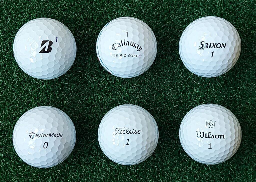 six golf balls on artificial turf