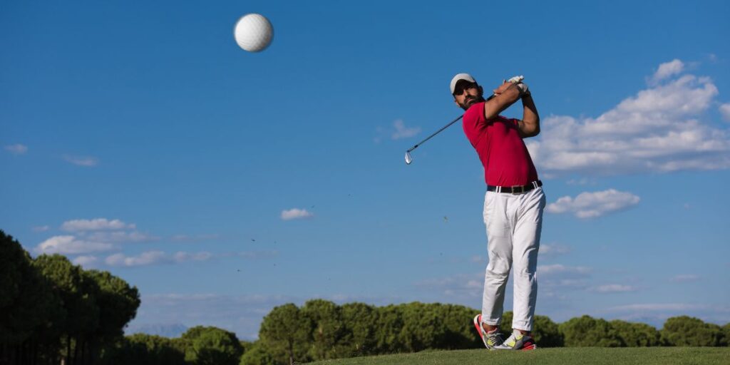 golf ball in the air after being hit by a golfer