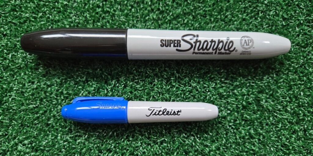 two Sharpie permanent markers, the larger one is black and the smaller one is blue