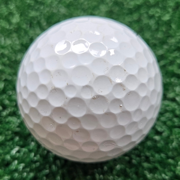 2025 Titleist Pro V1x golf ball showing scuffs and marks after a round of golf