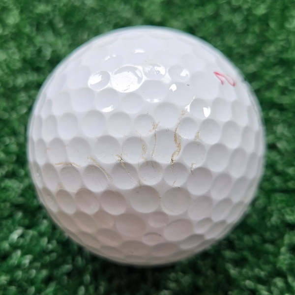 2025 Titleist Pro V1x golf ball showing scuffs and marks after a round of golf