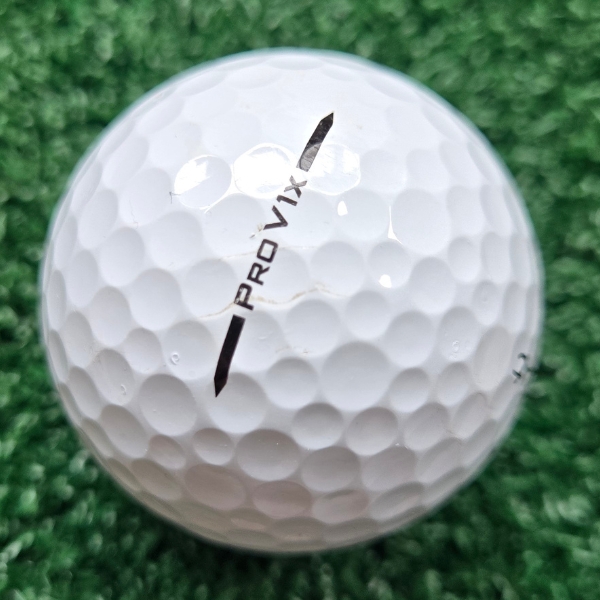 2025 Titleist Pro V1x golf ball showing scuffs and marks after a round of golf