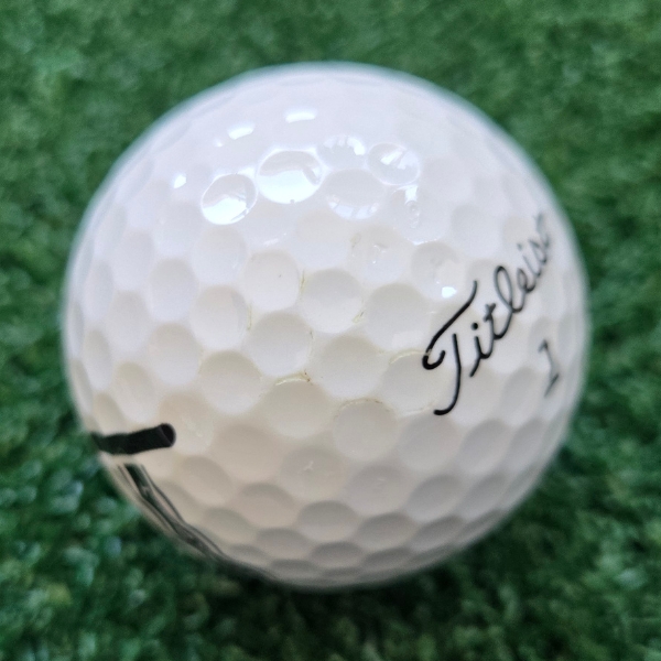 2024 Titleist Tour Soft Golf Ball showing marks and scuffs on the ball after a round of golf