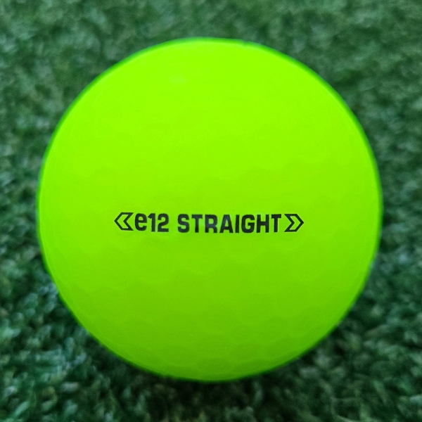 2025 Bridgestone e12 Straight Matte Green Golf Ball showing the putting alignment that reads "e12 Straight" between two small arrows on each side