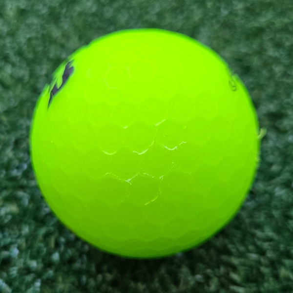 2025 Bridgestone e12 Straight Matte Green Golf Ball showing scuffs and marks on the ball after a round of golf