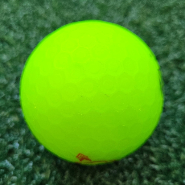 2025 Bridgestone e12 Straight Matte Green Golf Ball showing scuffs and marks on the ball after a round of golf