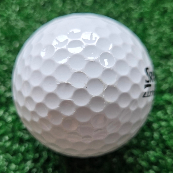 2025 Srixon Ultispeed Golf Ball showing scuffs and marks on the ball after a round of golfing