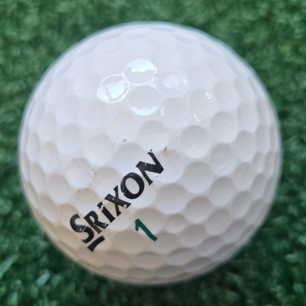 2025 Srixon Soft Feel golf ball showing the scuffs and marks after a round of golf
