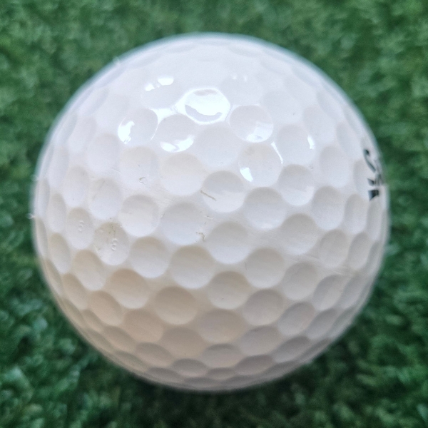 2025 Srixon Soft Feel golf ball showing the scuffs and marks after a round of golf