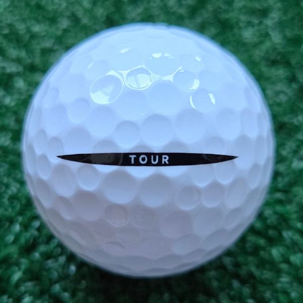 2024 Vice Tour Golf Ball showing the putting alignment with the world 'Tour" inside a black line with pointy edges on each side